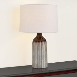 Venus de Milo — aged brass ceramic lamp beside a classical sculpture replica in a formal transitional living room