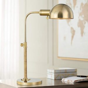 Cat sculpture — adjustable brass lamp on a console beside a bronze cat sculpture illuminated from the side in a transitional room