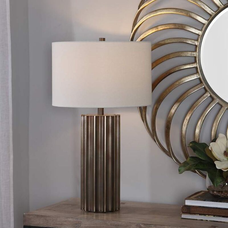 Wolf sculpture — gunmetal fluted lamp on a console beside a dark iron wolf sculpture in a contemporary nature-forward room