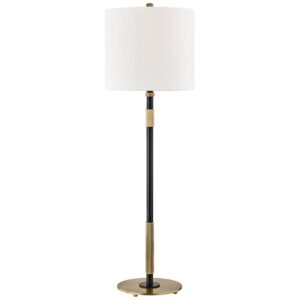 Unusual ruffled fabric lamp shade in ivory on a brass table lamp in a traditional bedroom