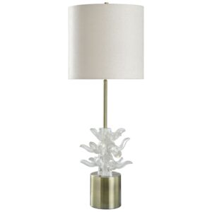 Crystal table lamp refracting light in a dark navy living room — prisms of warm light on the surrounding walls