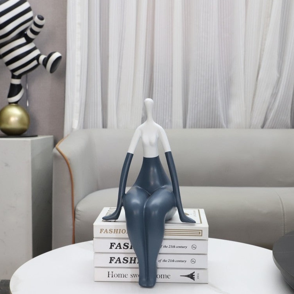 Sculptural table lamp — aged brass and ceramic Affogato lamp on a living room end table with cream shade in a transitional room