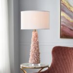 Crystal table lamps on a dining room sideboard — matched pair flanking a gold mirror above a dark sideboard