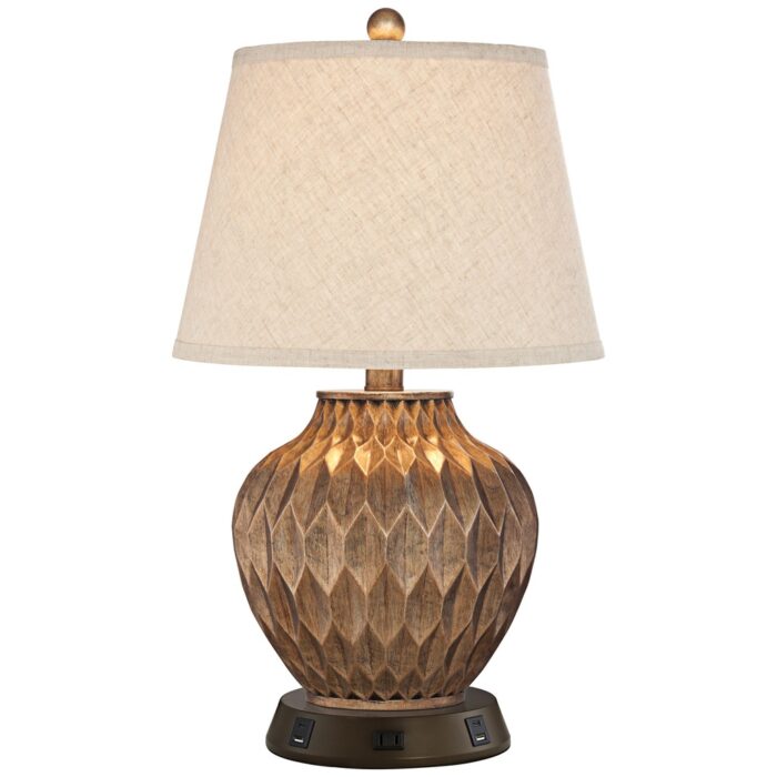 Table lamps for guest bedroom — warm ceramic lamp on a styled nightstand with a book, small plant, and phone charger