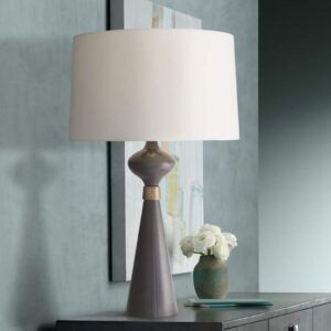 Statement entry table lamp pair — gold leaf sculptural lamps on a wide console with a tall rectangular mirror