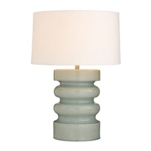 Mercury glass table lamp reflecting warm LED light across a living room console — shimmer and depth effect