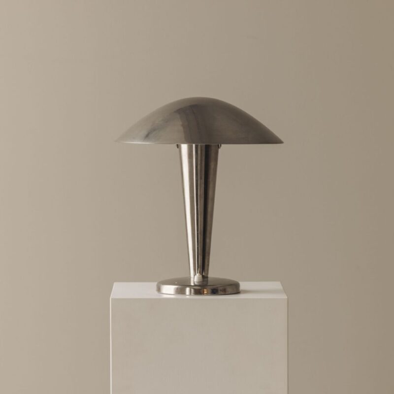 Collection of sconce lamp shades in different styles — empire, drum, bell, and half-shade — displayed on brass wall sconces