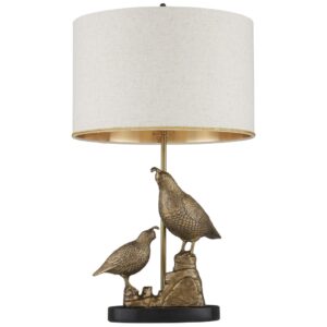 Aged brass metal table lamp beside a wood base table lamp on a styled shelf — material comparison