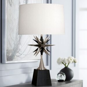 Baroque sculpture style — bronze accent lamp creating warm side light on a baroque figurine in a formally arranged traditional living room