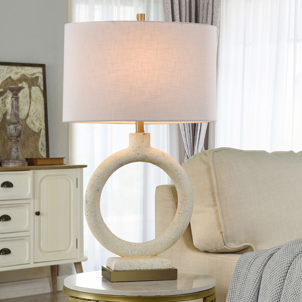 Matching bedside lamps — identical pair of brass ceramic lamps on either side of a bed with white bedding
