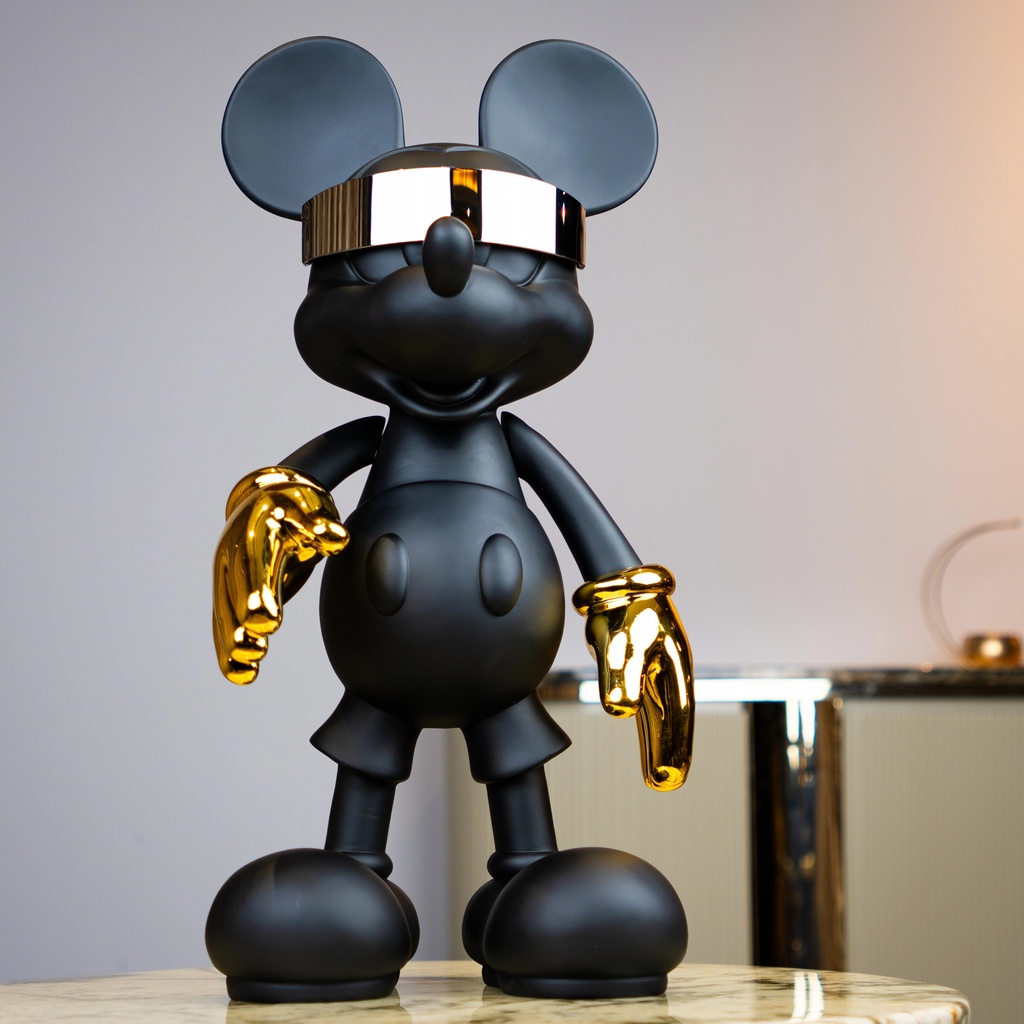 How to choose sculpture material for home — aged brass ceramic lamp beside sculptures in multiple materials showing material decision process
