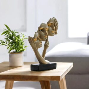 How to choose sculpture material for home — aged brass ceramic lamp beside sculptures in different materials on a transitional console