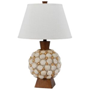 Coastal bedroom with pale aqua table lamp, rattan nightstand, and driftwood decorative objects