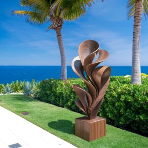 Botanical garden sculpture display inspiration — pale blue ceramic lamp beside a botanical sculpture composition with plants and stone accessories on a garden room console