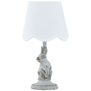 Mini table lamp on a compact nightstand versus an arc floor lamp reaching over a reading chair