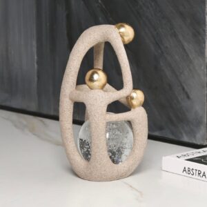 Stone sculpture for garden and home — natural beige lamp on a covered patio table with a cast stone sculpture visible in the adjacent garden