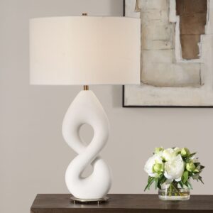 Before and after — colorful lamp creating visual noise versus a clean white ceramic lamp in a neutral bedroom