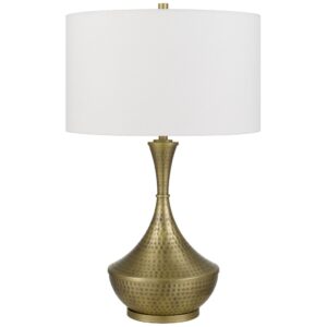 Brass table lamp being polished with a soft cloth to restore warm metallic shine