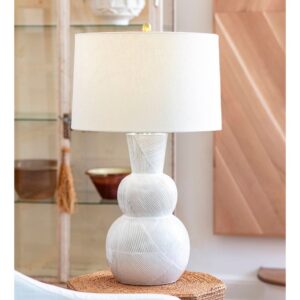 Traditional master bedroom with matched brass crystal table lamps flanking a tufted headboard