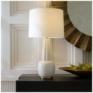 Copper table lamp and ceramic vase on a round marble side table — warm metallic styling in an eclectic living room