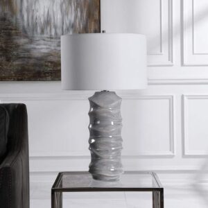 Ceramic sculpture ideas home decoration — aged brass ceramic lamp on a transitional console beside a stoneware figurine