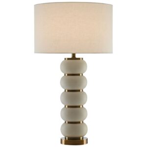 Pale blue ceramic table lamp on a white linen nightstand in a serene coastal bedroom