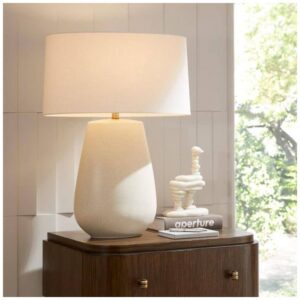 Dining room sideboard styled with crystal buffet lamps, books, and ceramic objects in a formal traditional room