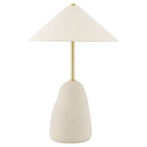 Navy lamp styling idea — blue ceramic lamp, leather-bound books, and warm brass tray on a nightstand