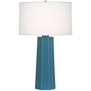 Purple crystal table lamp reflecting light across a dark bedroom wall — jewel-toned lighting effect