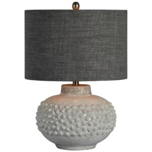 Cordless table lamp on a floating shelf with phone charging via USB on the shelf surface below