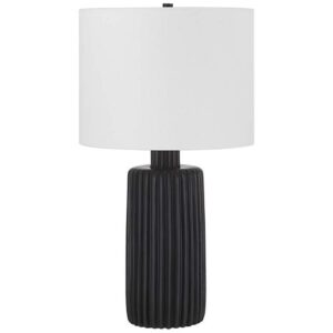 Antique brass ceramic table lamp with cream empire shade in a formal traditional living room arrangement