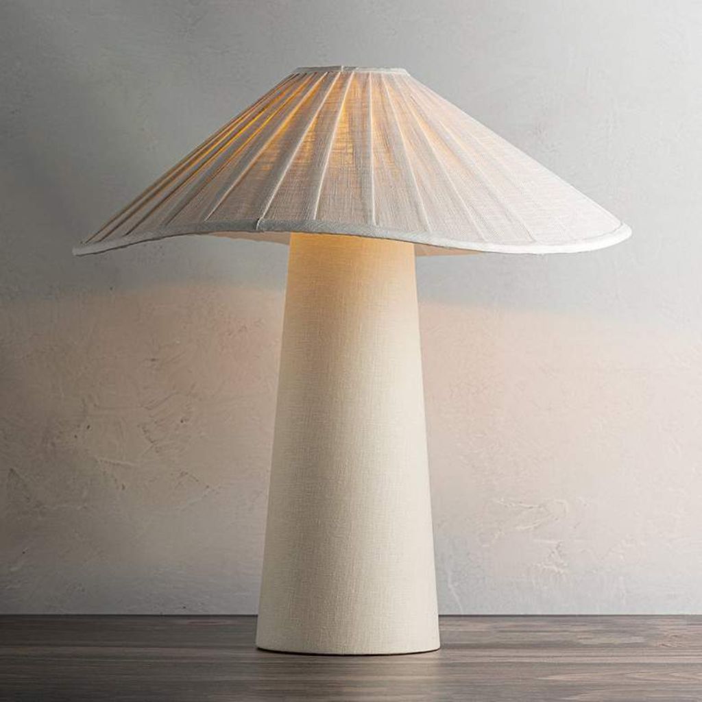 Buffet table lamps — matched brass pair flanking a mirror on a narrow hallway console with flowers and books