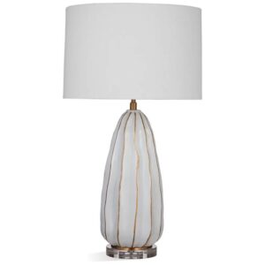 Black metal table lamp on a contemporary side table — matte black column with white drum shade and minimal accessories