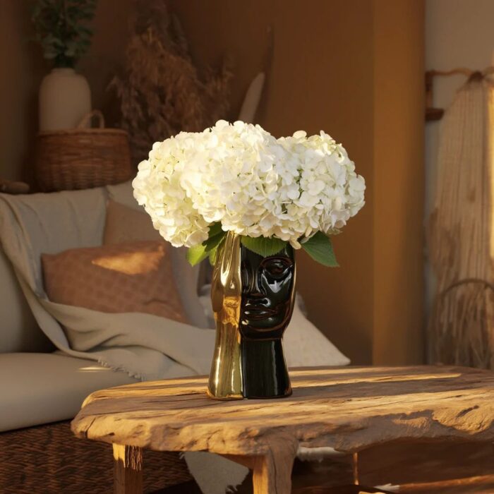Ceramic sculpture ideas for home decoration — granite ceramic lamp beside a ceramic sculpture on a natural wood console