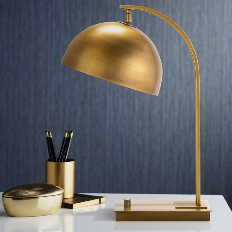 Gold table lamps on a white marble nightstand in a glamorous bedroom — paired with cream bedding and gold accessories