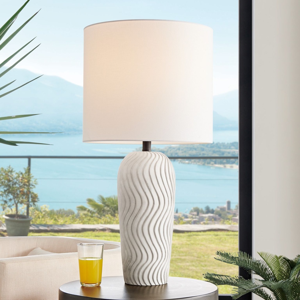 Cordless table lamps for living room — wireless artisan ceramic lamp on a side table beside a sofa with no outlet in sight