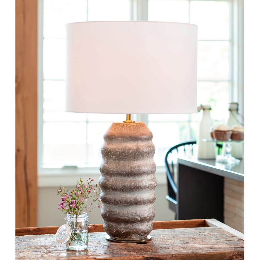 Console table lamps — matched pair of brass lamps flanking a mirror on a living room console
