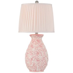 Intentionally mismatched bedside lamps — one green ceramic and one brass lamp on a shared nightstand