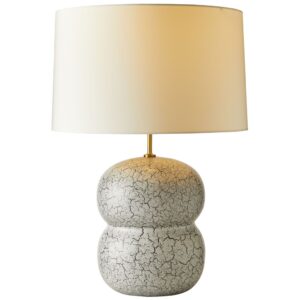 Luxury table lamp on a living room console — gold leaf sculptural lamp flanking a mirror above a sideboard
