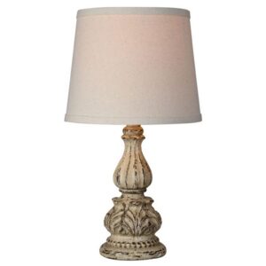 Small mini table lamp with USB port on a home office desk next to a laptop and notebook