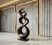 Sculpture gardens guide for art and travel — bronze accent lamp beside a cast bronze sculpture on a garden room console