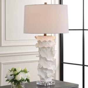 Ceramic sculpture ideas for home decoration — granite-textured ceramic lamp beside a ceramic sculpture on a natural wood console