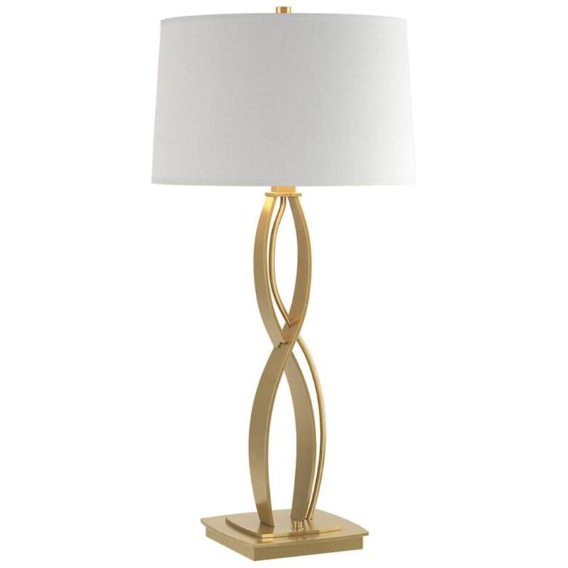 Table lamps tall — a 40-inch statement brass column lamp on a console beside a sofa with a high ceiling room