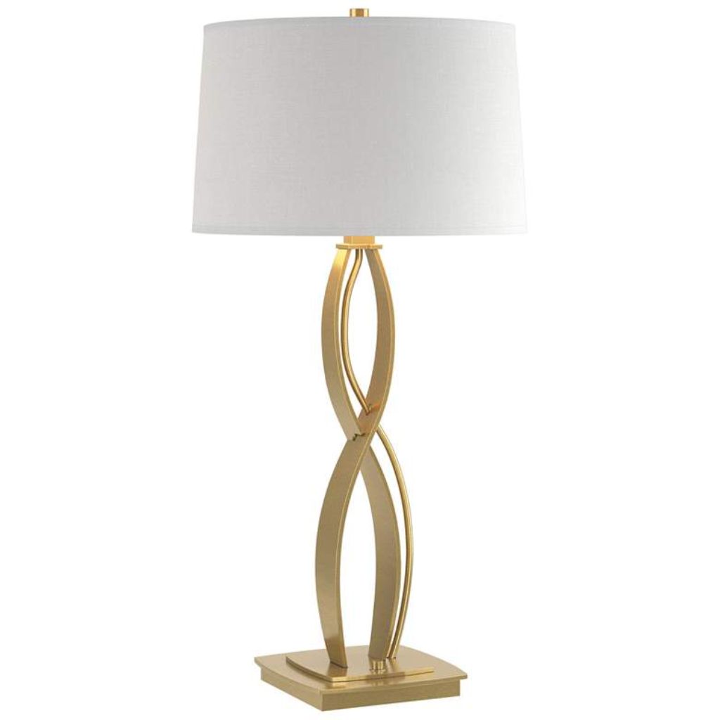 Table lamps tall — a 40-inch statement brass column lamp on a console beside a sofa with a high ceiling room