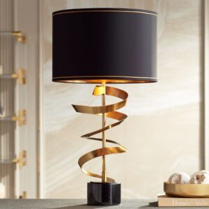 Art deco table lamp with purple glass base and gold hardware on a marble surface in a glamorous room