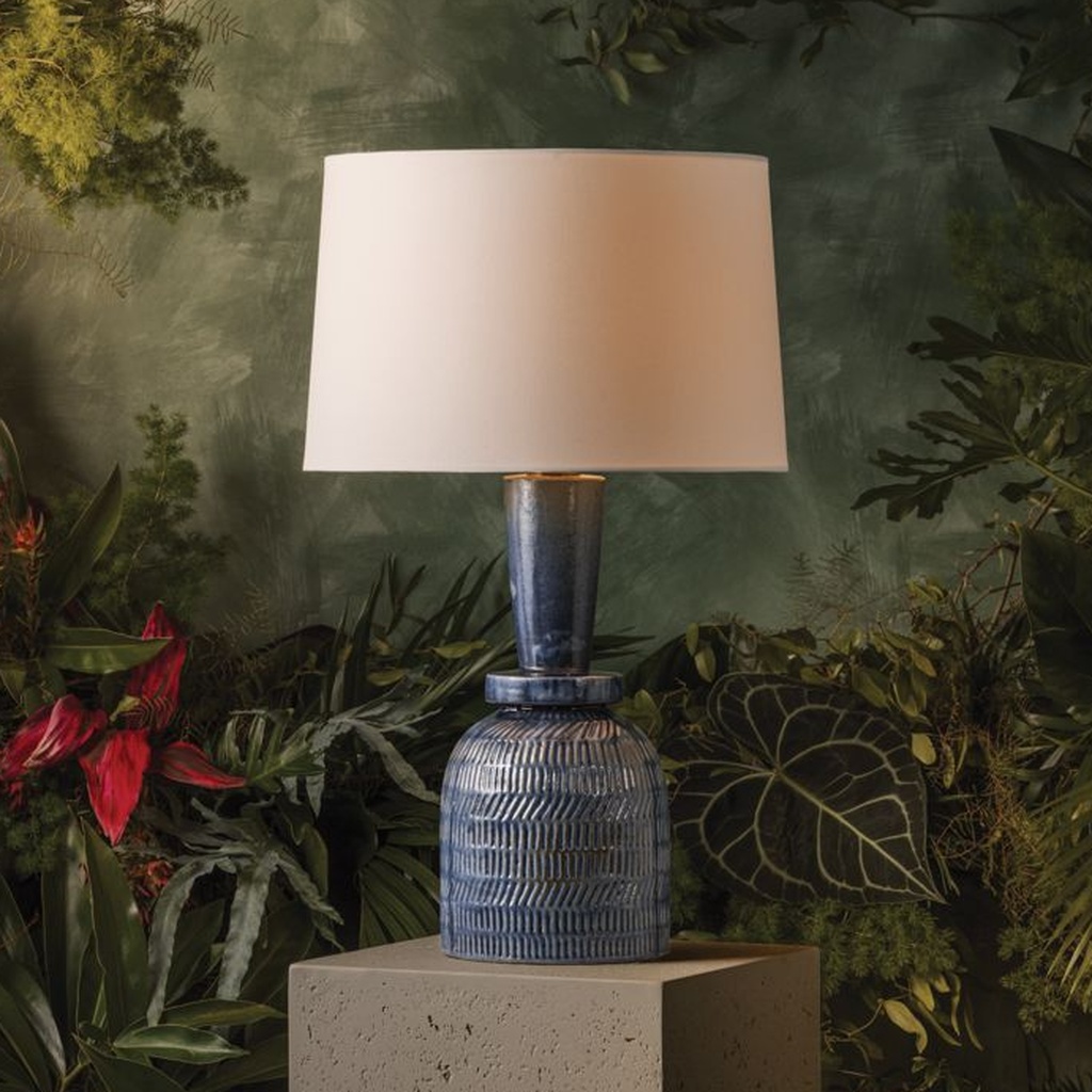 Interior designer choosing a ceramic table lamp for a transitional living room side table