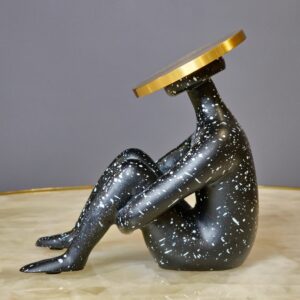 Welding sculpture techniques for home artists — gunmetal fluted lamp in a metal sculpture studio beside finished welded steel sculptures and metalworking tools