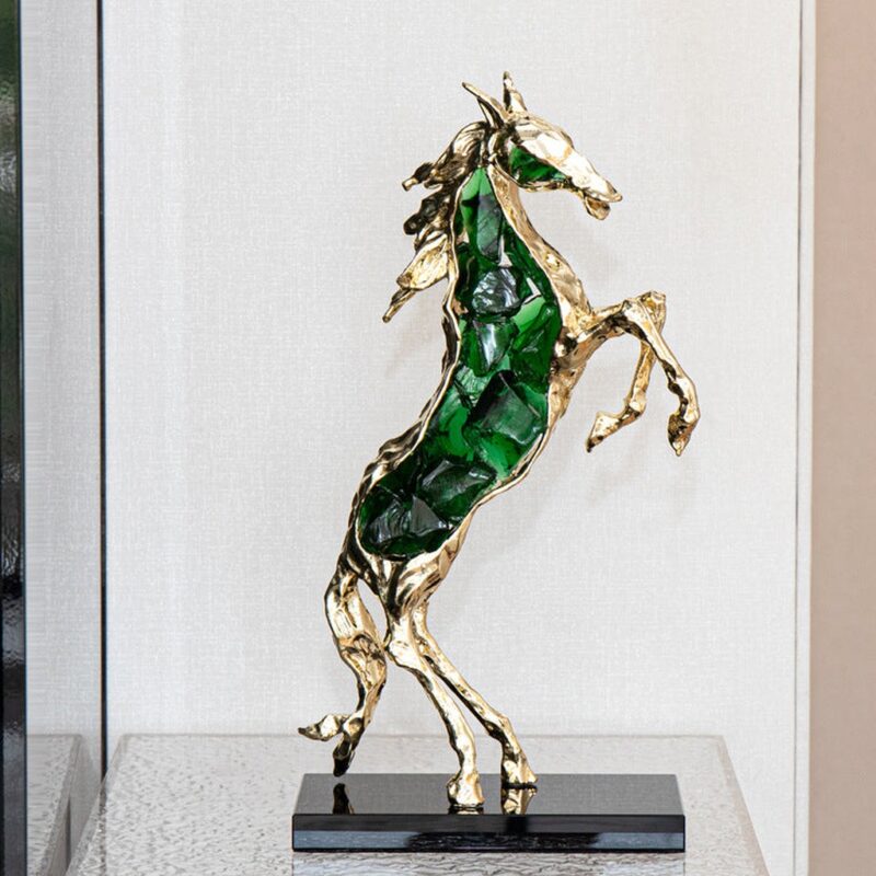 How to choose a sculpture for your living room — bronze accent lamp on a console showing warm material, correct scale, and considered placement