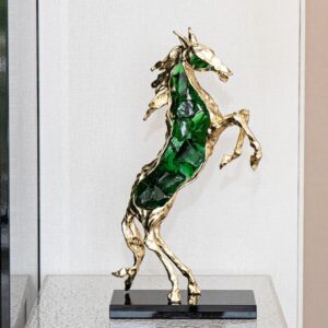 How to choose sculpture for living room — gold leaf lamp as counterweight composition beside a primary sculpture on a formal living room console