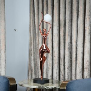 Michelangelo sculpture influence on home design — granite ceramic lamp on a formal console beside a classical marble-style figurine in a traditionally styled living room